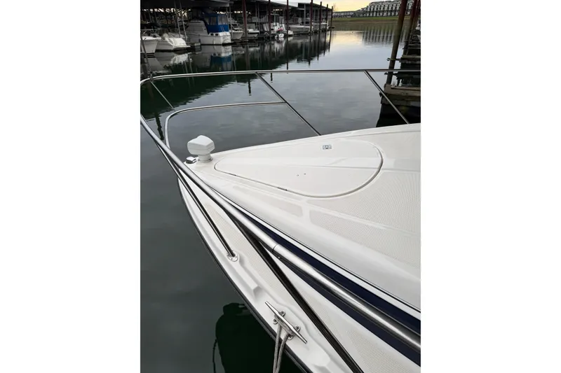 Slide: The Image of 1998 Bayliner 3685 Avanti Sunbridge bow at marina, calm water reflection. - 42