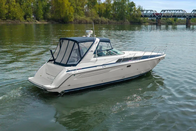 Slide: The Image of 1998 Bayliner 3685 Avanti Sunbridge cruising on a scenic river. - 43