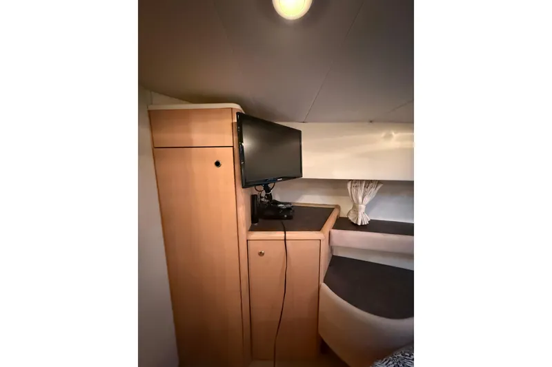 Slide: The Image of Interior of 1998 Bayliner 3685 Avanti Sunbridge with TV and wooden cabinetry. - 5