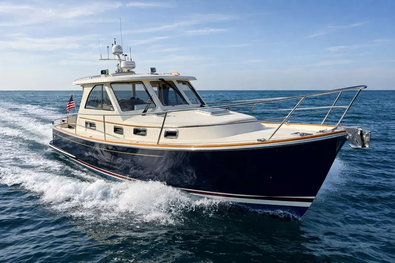 The Image of 2007 Legacy Yachts 32 cruising on open water under clear skies. - 0