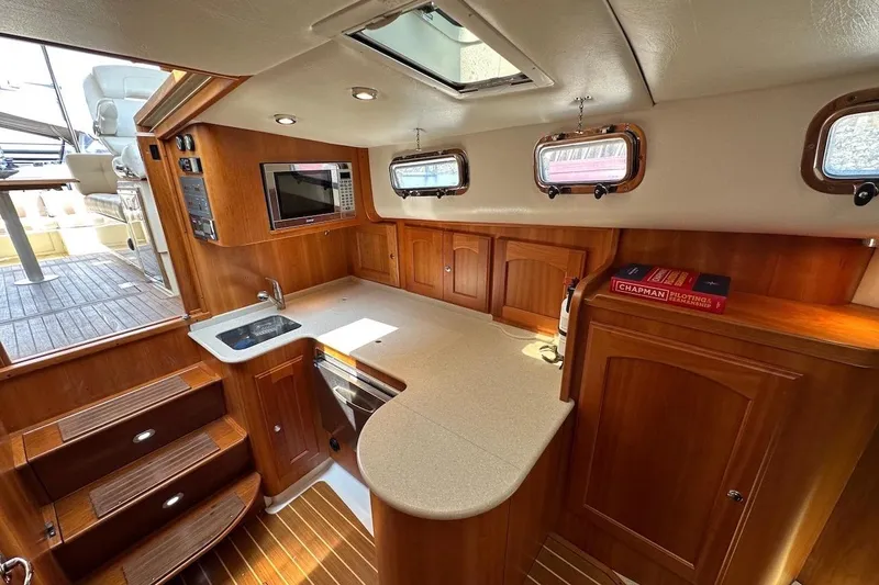Slide: The Image of Luxurious 2007 Legacy Yachts 32 interior with wooden cabinetry and modern amenities. - 6