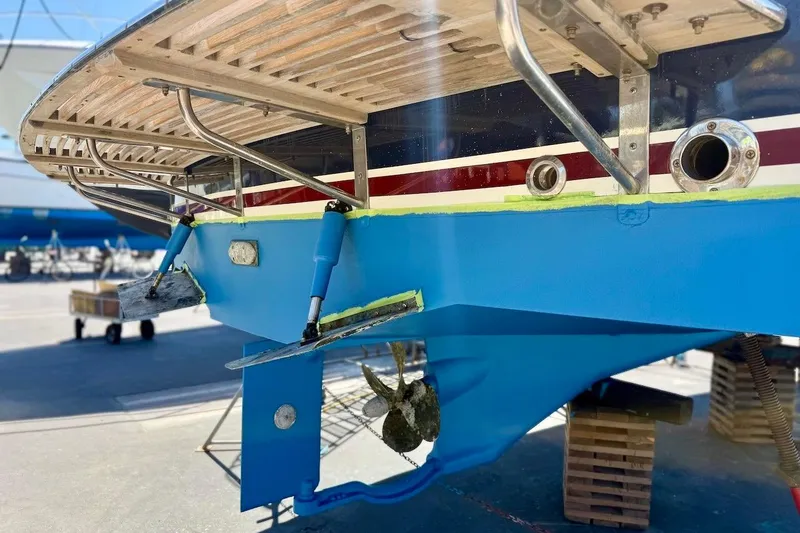 Slide: The Image of 2007 Legacy Yachts 32, blue hull, dry docked for maintenance, stern view. - 8