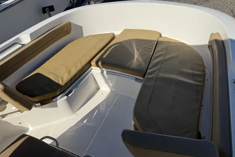 Slide: The Image of 2022 2 Bar T22 CX boat seating area with beige cushions. - 14
