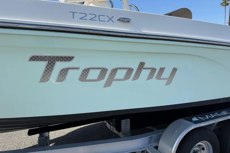 Slide: The Image of 2022 2 Bar T22 CX boat with "Trophy" logo on trailer. - 23