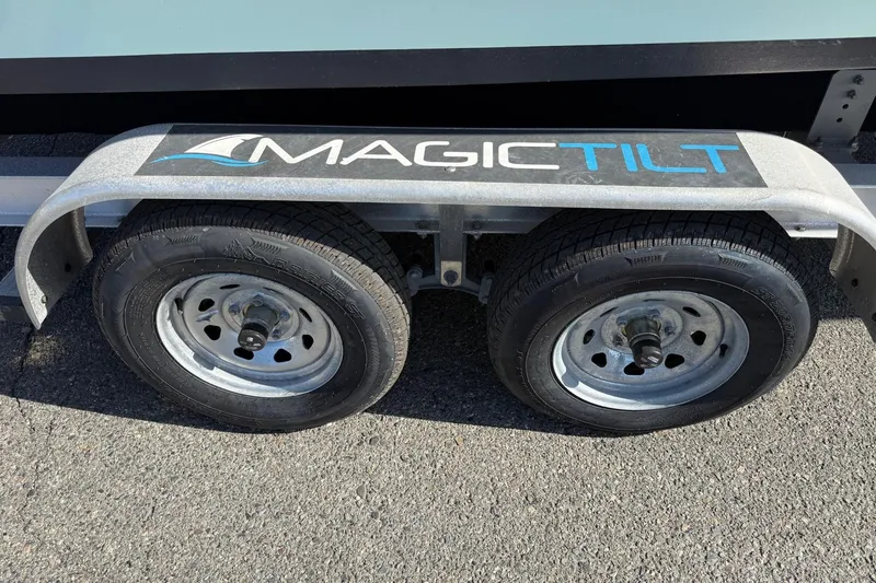 Slide: The Image of Trailer with dual wheels and "Magic Tilt" branding, 2 Bar T22 CX 2022 model. - 6
