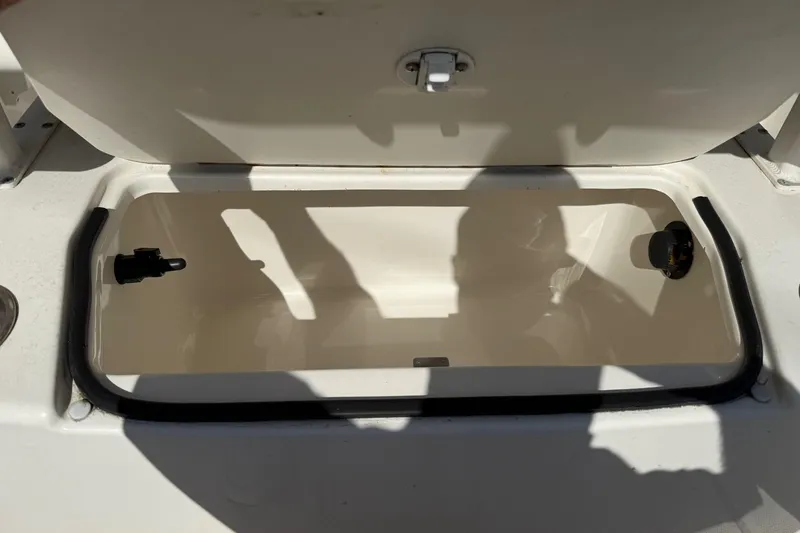Slide: The Image of Open storage compartment on a 2022 2 Bar T22 CX boat, showing interior details. - 18