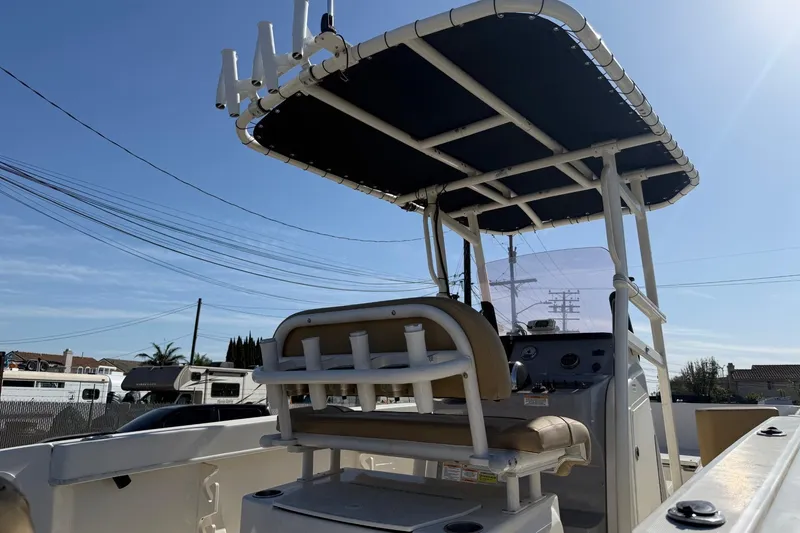 Slide: The Image of 2022 2 Bar T22 CX boat with T-top and console, parked outdoors. - 8