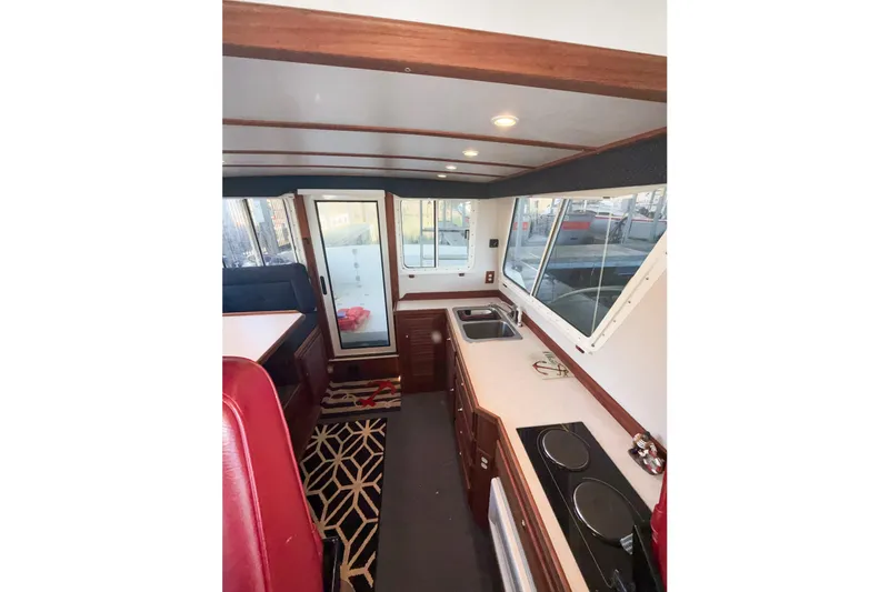 Slide: The Image of Interior of 2003 SeaSport Pacific 3200 boat with kitchen and seating area. - 11
