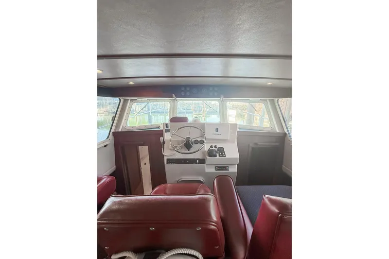 Slide: The Image of Interior view of 2003 SeaSport Pacific 3200 boat cockpit with steering wheel and controls. - 12
