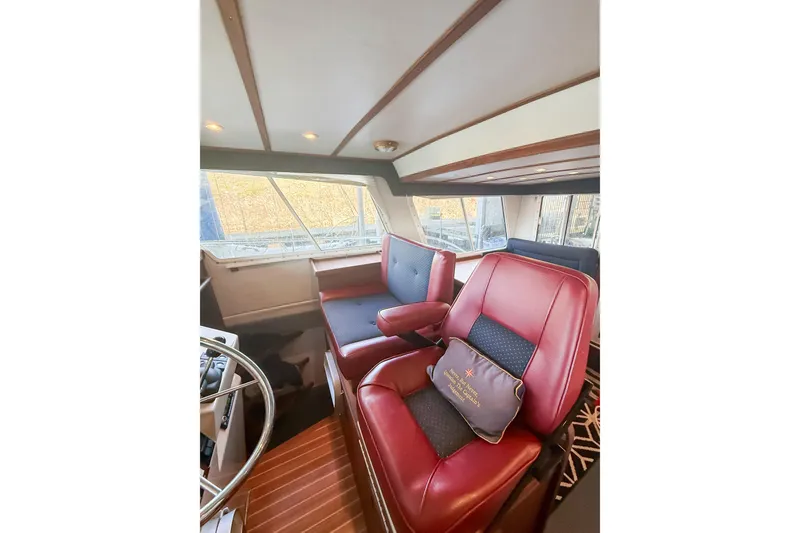 Slide: The Image of Interior of 2003 SeaSport Pacific 3200 boat with red and black seating. - 14