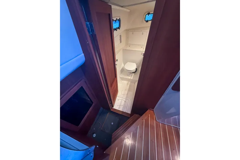 Slide: The Image of 2003 SeaSport Pacific 3200 boat interior with wooden stairs and compact bathroom. - 18