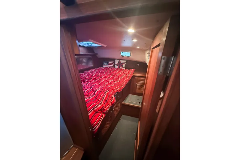 Slide: The Image of Cozy cabin interior of 2003 SeaSport Pacific 3200 with red-striped bedding. - 21