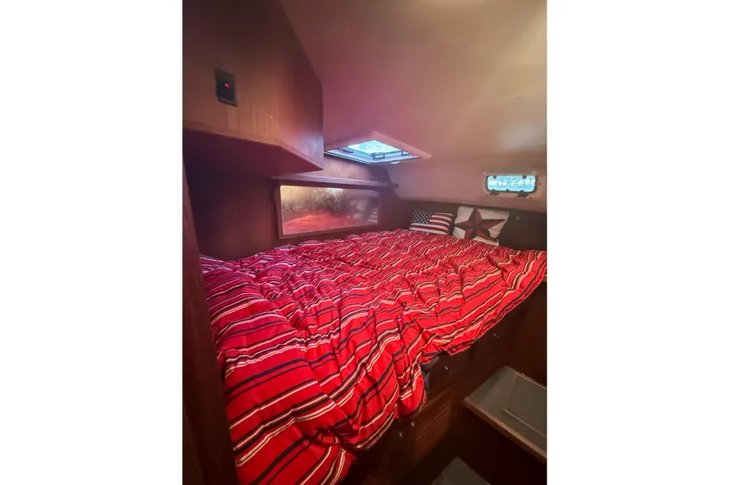 Slide: The Image of Cozy cabin interior of 2003 SeaSport Pacific 3200 with red-striped bedding. - 23