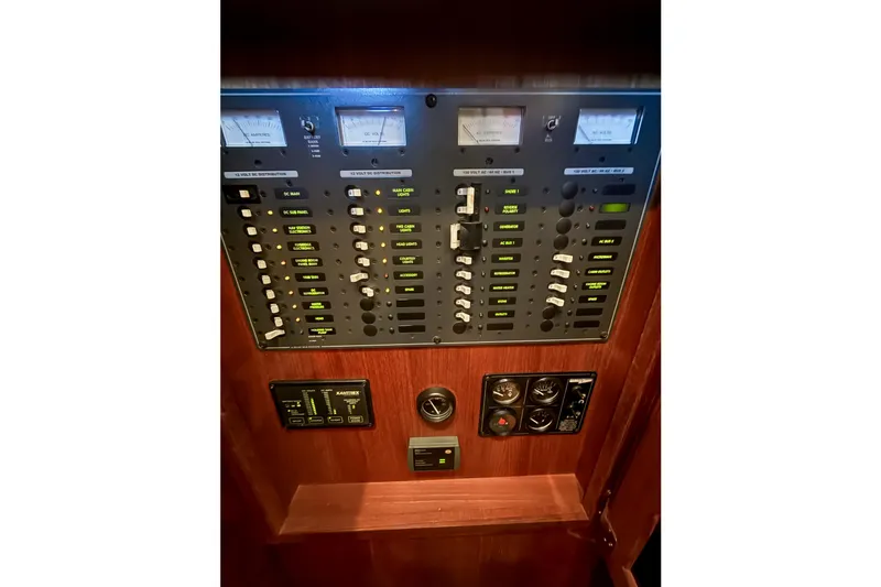 Slide: The Image of Electrical control panel of 2003 SeaSport Pacific 3200 boat, featuring various switches and gauges. - 24