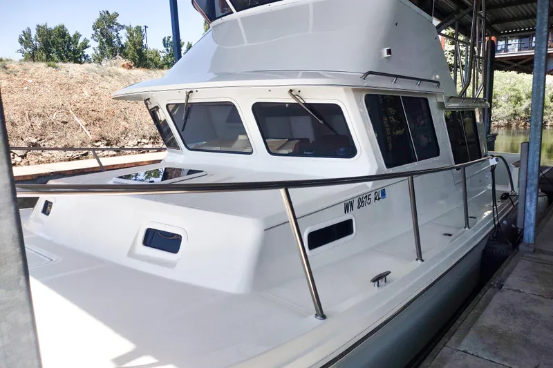 Slide: The Image of 2003 SeaSport Pacific 3200 boat docked, featuring sleek design and spacious cabin. - 30