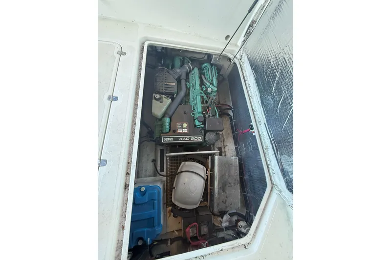 Slide: The Image of Engine compartment of a 2003 SeaSport Pacific 3200 boat, featuring a Volvo Penta KAD 300 engine. - 37