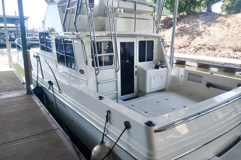 Slide: The Image of 2003 SeaSport Pacific 3200 boat docked, featuring spacious deck and modern design. - 4