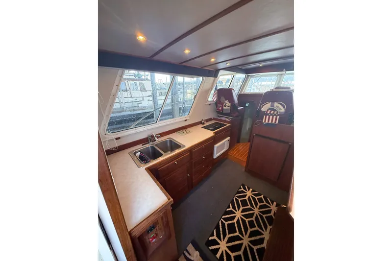 Slide: The Image of Interior of 2003 SeaSport Pacific 3200 boat with kitchen and helm area. - 5