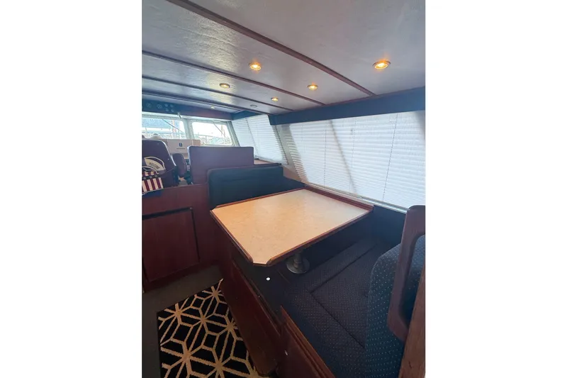 Slide: The Image of Interior of 2003 SeaSport Pacific 3200 boat with dining area and seating. - 7