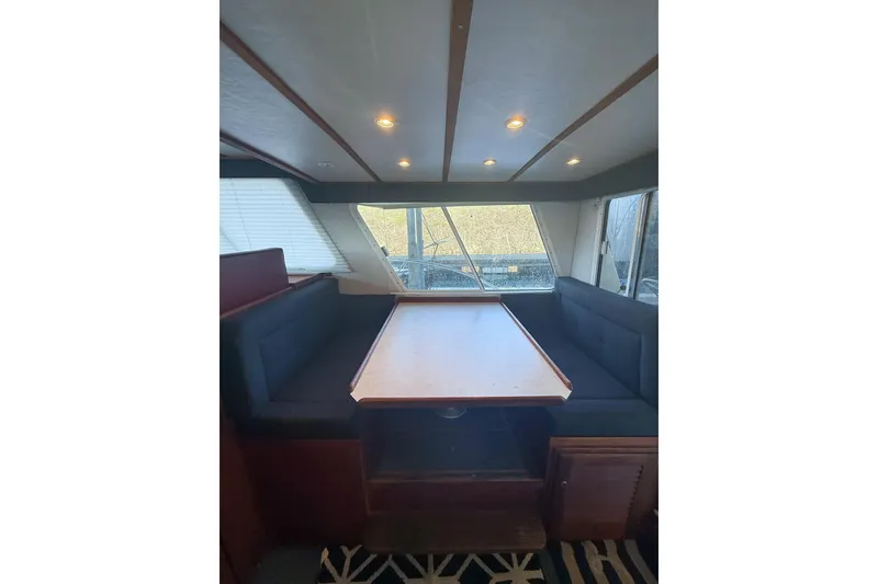 Slide: The Image of Interior of 2003 SeaSport Pacific 3200 boat with dining area and windows. - 8