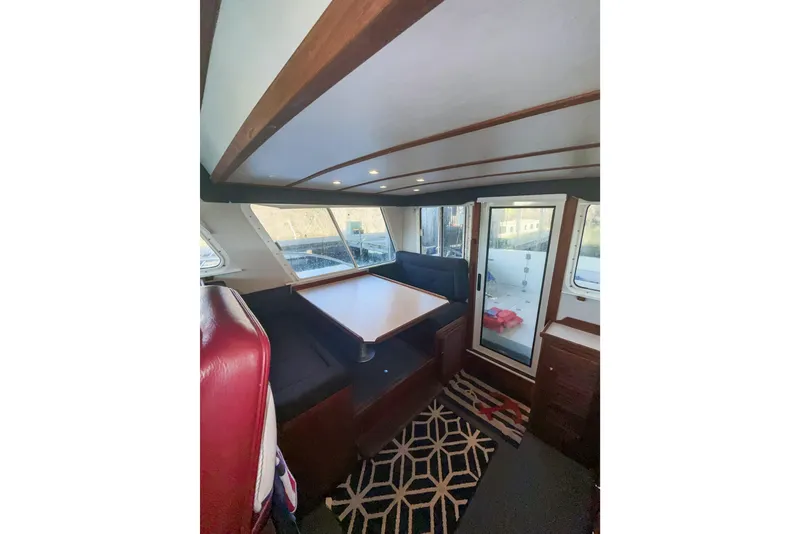 Slide: The Image of Interior of 2003 SeaSport Pacific 3200 boat with seating and table. - 9