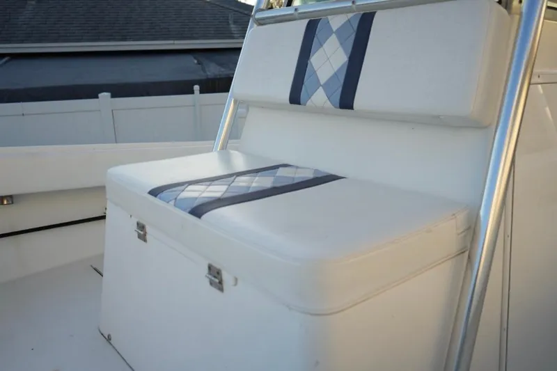 Slide: The Image of 1999 Regulator 26 Forward Seating boat with cushioned seating and storage. - 14