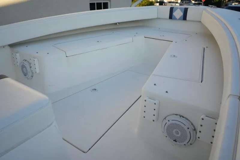 Slide: The Image of 1999 Regulator 26 Forward Seating boat interior with storage compartments and speakers. - 15