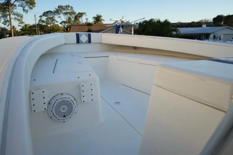 Slide: The Image of 1999 Regulator 26 Forward Seating boat interior with speaker and seating area. - 16