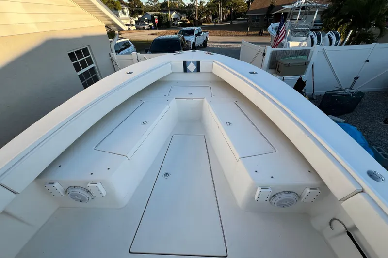 Slide: The Image of 1999 Regulator 26 Forward Seating boat with spacious deck and storage compartments. - 17