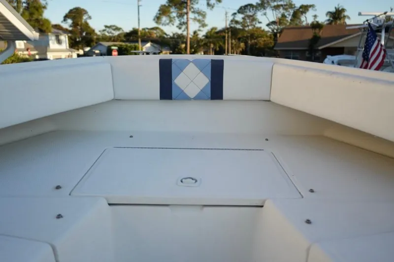 Slide: The Image of 1999 Regulator 26 Forward Seating boat interior with white and blue upholstery. - 18