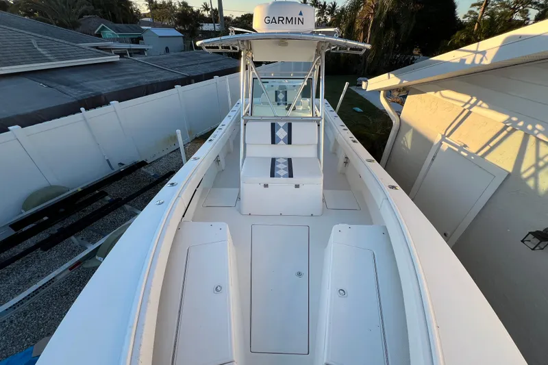 Slide: The Image of 1999 Regulator 26 Forward Seating boat with Garmin equipment, docked near residential area. - 20