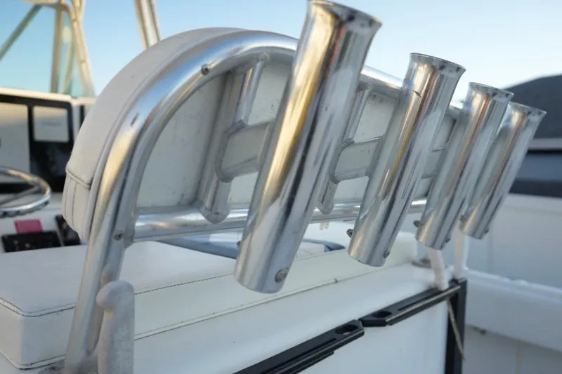 Slide: The Image of 1999 Regulator 26 Forward Seating boat with rod holders and helm detail. - 9