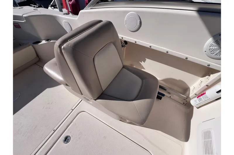 Slide: The Image of 2008 Scout 205 Dorado boat interior with beige seating and storage compartment. - 19