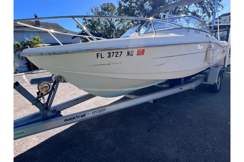 Slide: The Image of 2008 Scout 205 Dorado boat on trailer, parked outdoors. - 2