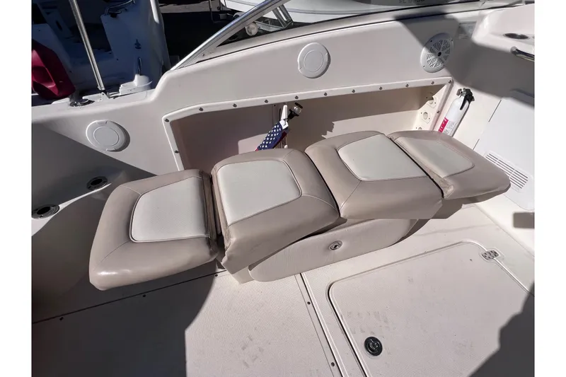 Slide: The Image of 2008 Scout 205 Dorado boat interior with beige seating and storage compartment. - 20