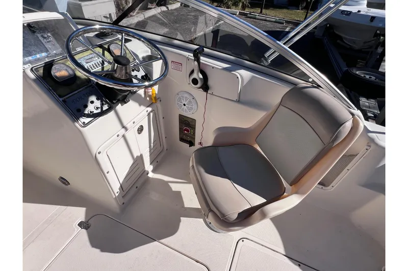 Slide: The Image of 2008 Scout 205 Dorado boat cockpit with steering wheel and comfortable seating. - 21