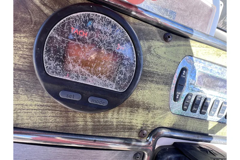 Slide: The Image of Close-up of a 2008 Scout 205 Dorado boat dashboard with tachometer and controls. - 23