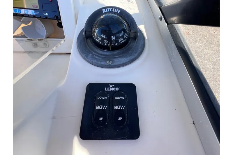 Slide: The Image of Compass and Lenco trim tab controls on 2008 Scout 205 Dorado boat dashboard. - 27
