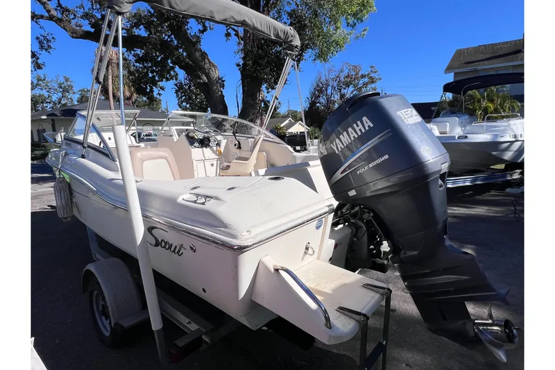 Slide: The Image of 2008 Scout 205 Dorado boat with Yamaha outboard motor, parked on a trailer. - 3