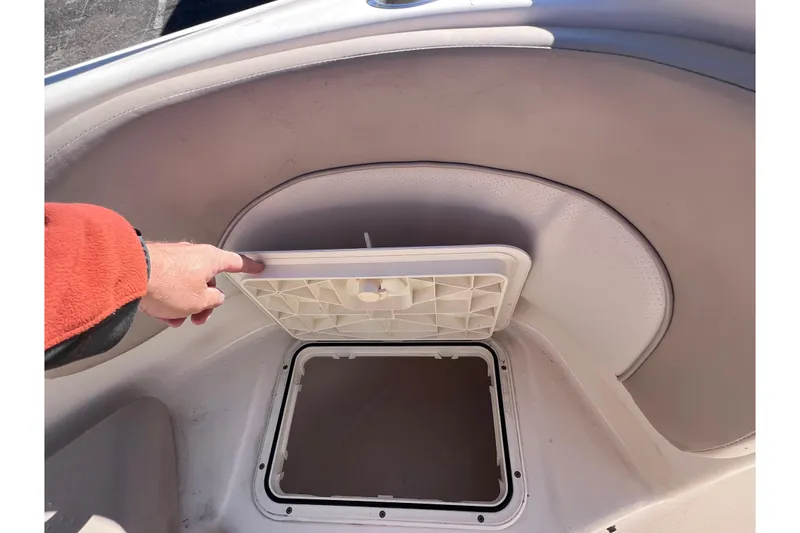 Slide: The Image of Hand opening storage compartment on 2008 Scout 205 Dorado boat. - 31