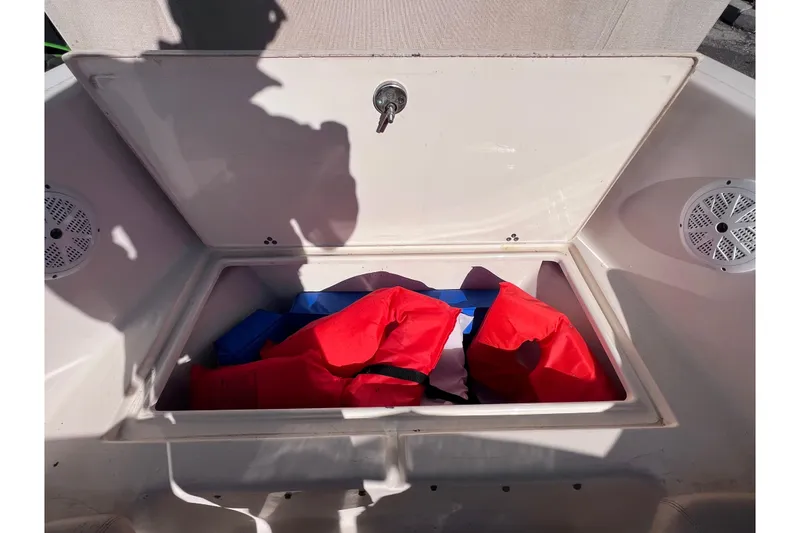 Slide: The Image of Open storage compartment on 2008 Scout 205 Dorado boat with life jackets inside. - 32