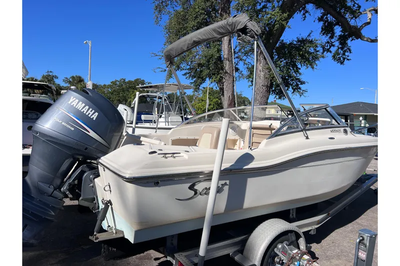 Slide: The Image of 2008 Scout 205 Dorado boat with Yamaha engine on trailer, parked outdoors. - 4