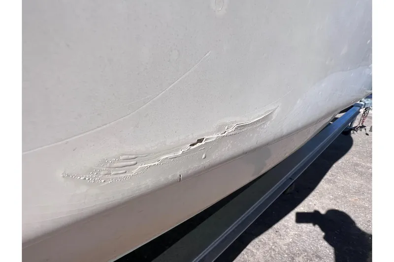 Slide: The Image of Damaged hull of 2008 Scout 205 Dorado boat on trailer. - 7
