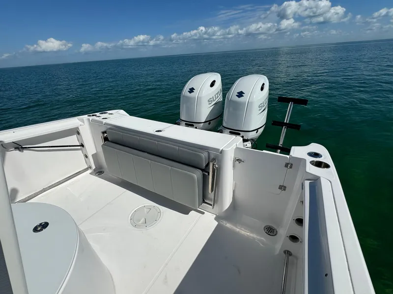 Slide: The Image of 2022 Aquasport 2500 Center Console boat with dual Suzuki outboard motors. - 12