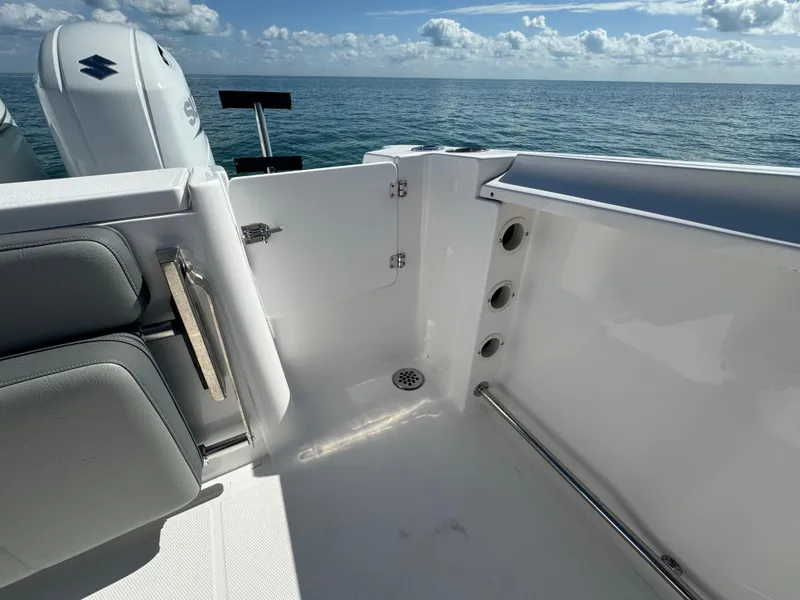 Slide: The Image of 2022 Aquasport 2500 Center Console boat interior with ocean view. - 13