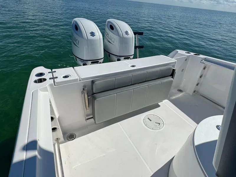 Slide: The Image of 2022 Aquasport 2500 Center Console boat with twin Suzuki outboard engines. - 14