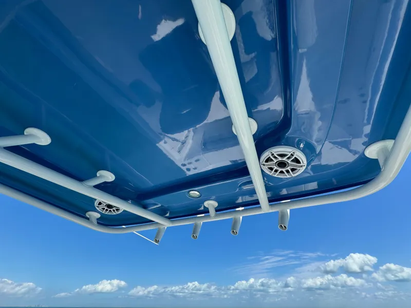 Slide: The Image of 2022 Aquasport 2500 Center Console boat with blue T-top and rod holders. - 30