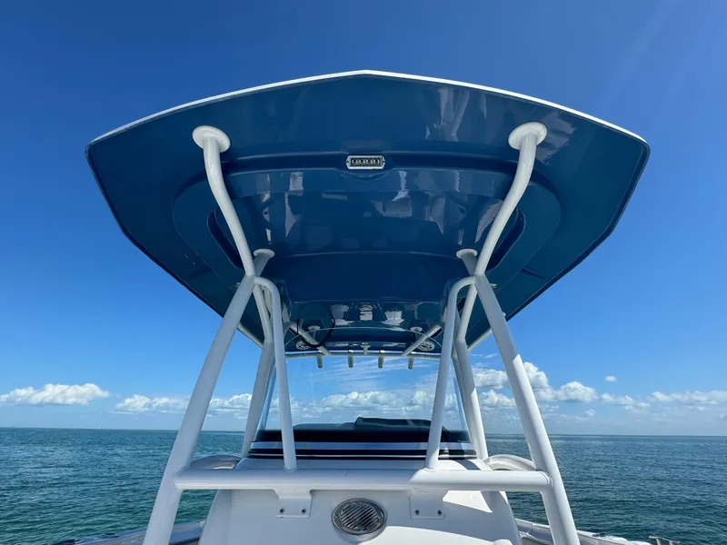 Slide: The Image of 2022 Aquasport 2500 Center Console boat on open water under clear blue sky. - 39