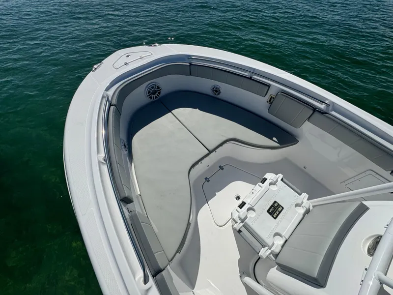 Slide: The Image of 2022 Aquasport 2500 Center Console boat bow area on calm water. - 45