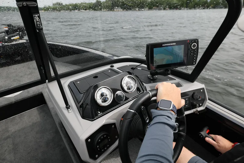 Slide: The Image of 2026 Starcraft Titan 186 boat dashboard with GPS navigation on a lake. - 8